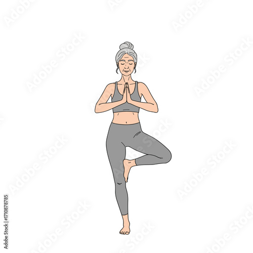 An elderly woman practicing yoga in tree pose, placing her hands in a mudra of love and gratitude, maintaining balance, and closing her eyes, symbolizing calm and control over her body.