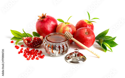 Pomegranates, apples and honey on white background, traditional food of Jewish New Year - Rosh Hashanah.