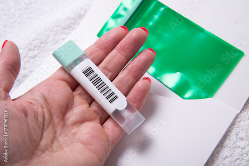 Woman Holding Stool Collection Tube for Colon Cancer Screening with Barcode
