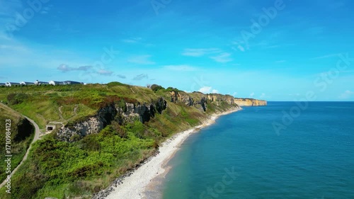 Aerial view of Omaha Beach in Normandy, France, with Flower Camping Omaha Beach nearby, historic WWII D-Day landing site, sandy coastline, green fields, and holiday atmosphere