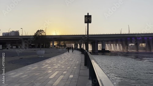 Business Bay waterfront, view of Dubai Water Canal and Sheikh Zayed road at sunset. June 2025. 