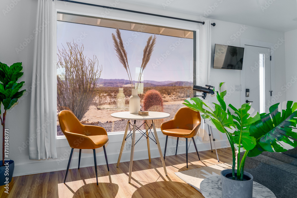 Fototapeta premium modern home with table chairs plants large window with a desert view joshua tree california