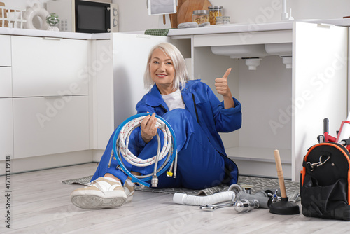 Mature female plumber with ...
