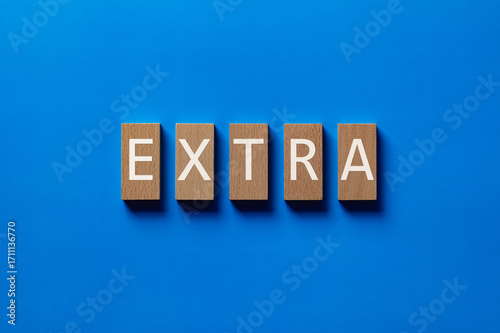 There is wood block with the word EXTRA. It is as an eye-catching image.