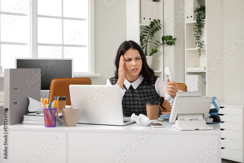 Tired young woman working w...