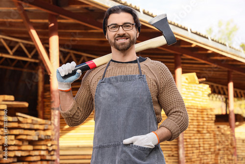 Male carpenter with axe at ...