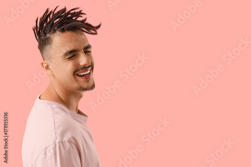 Young man with dreadlocks o...