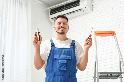 Male technician with repair...