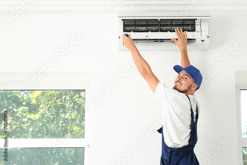 Male technician repairing a...