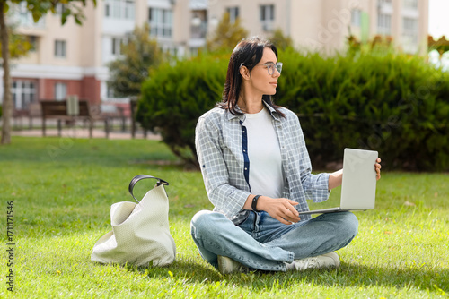 Young woman using laptop on...