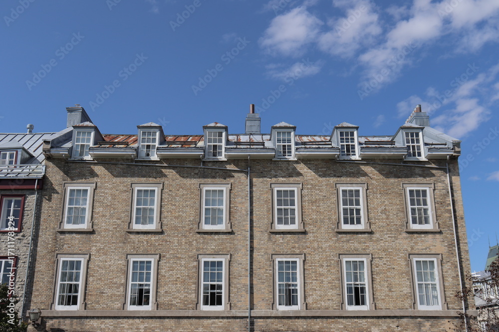 Fototapeta premium A view in summer of the Old Quebec in Canada with ancient architecture. Panorama of the old Quebec with ancient building. Historic building in Quebec city. Tourism and destination. Rust on the roof.