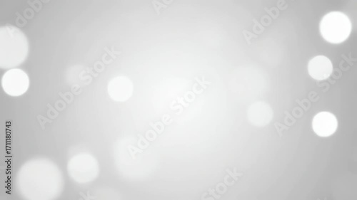 Monochromatic gray and white bokeh lights softly rippling and fading in a minimalist, seamlessly looping video gentle movement, defocused, softly rippling