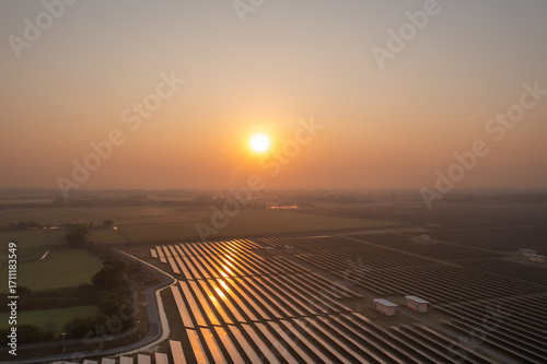Solar Farm (solar cell) on sunset background with electric power generation in agricultural area . Renewable green alternative energy. Power plant.Solar photovoltaic rows array ground mount system