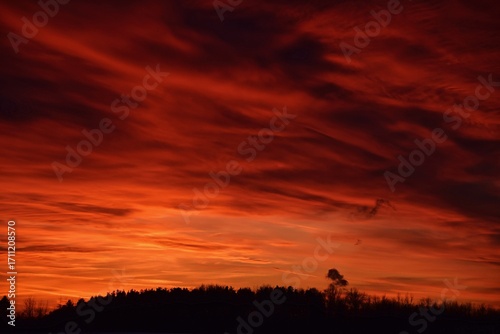 arafed sky with a red sky and a few clouds