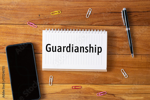 Guardianship written in a notebook on wooden desk 