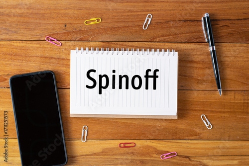 Spinoff written in a notebook on wooden desk