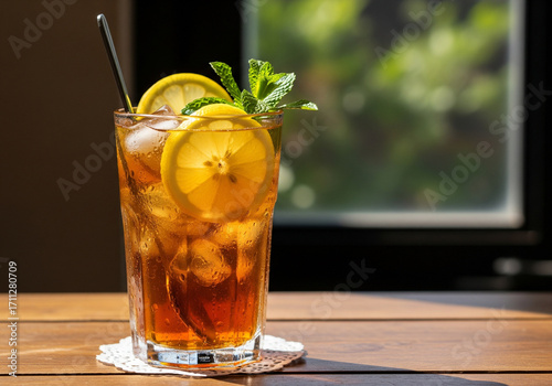 Refreshing Iced Tea with Lemon, Mint, and Ice on Wooden Table, Summer Drink.