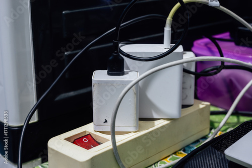 Cluttered and Overloaded Power Strip with Multiple Chargers and Tangled Wires