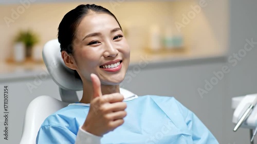 Happy Patient with Thumbs Up in Dental Office During Appointment