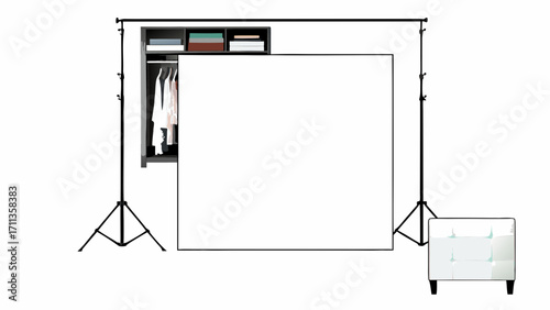 White blank frame stands in front of wardrobe and soft chair in photo studio setup