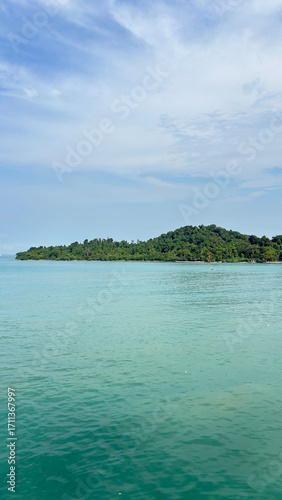 Serene Island Landscape with Calm Turquoise Water and Blue Sky