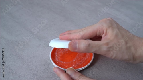 Opening Orange Dental Aligner Case that orthodontic mouthpiece storaged. Slow motion video.
