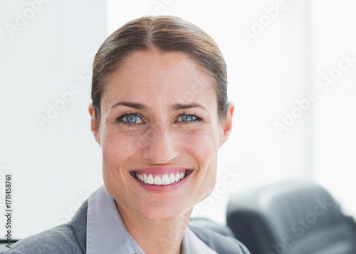 In modern office, businesswoman smiling confidently, showcasing professional success