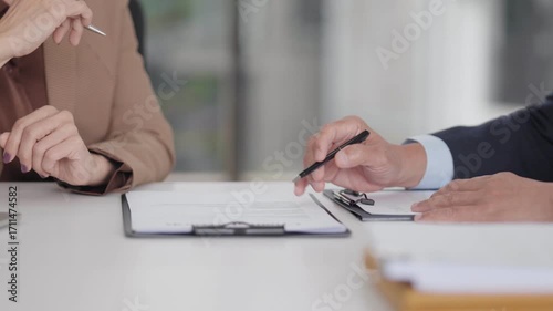 Legal professionals business clients review important documents discuss contract agreement formal consultation office meeting