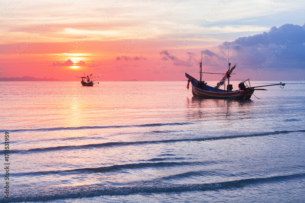 Fototapeta premium Sea sunset landscape, beautiful ocean sunrise, tropical island beach, fisherman boat, ship silhouette, blue waves, colorful pink red orange sky, water sun reflection, summer holidays, vacation, travel