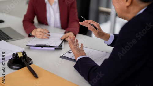 Asian legal professionals advise clients reviewing documents office business consultation expert justice guidance support