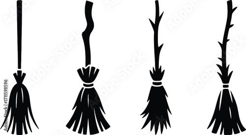 Four hand drawn silhouettes of witches brooms on a white background