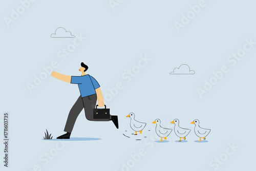 Being leader, businessman walks forward, followed by ducklings