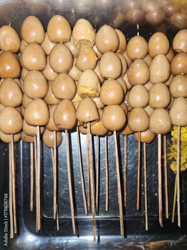 Quail egg satay is a beloved Indonesian snack, with skewered boiled quail eggs grilled or glazed in savory-sweet sauce, offering a tender and flavorful bite