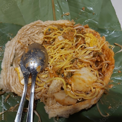 Toge Goreng (fried bean sprouts) is a traditional Indonesian street food of stir-fried bean sprouts served with rice cake, yellow noodles, and savory-sweet peanut and soy sauce
