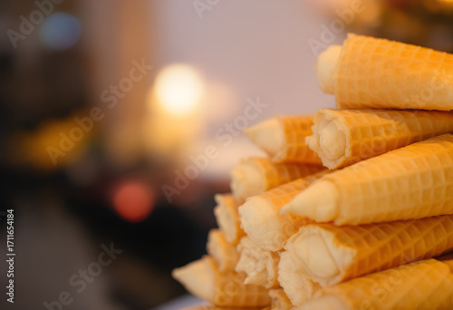 Wallpaper Mural Close-up of a Stack of Golden Waffle Cones Filled with Creamy Filling Torontodigital.ca