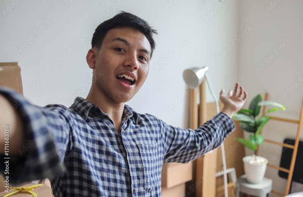 Fototapeta premium Camera POV of Cheerful Man Taking a Self Portrait in His New Home