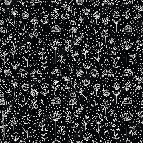 A whimsical black and white folk art pattern featuring small plants and scattered dots.