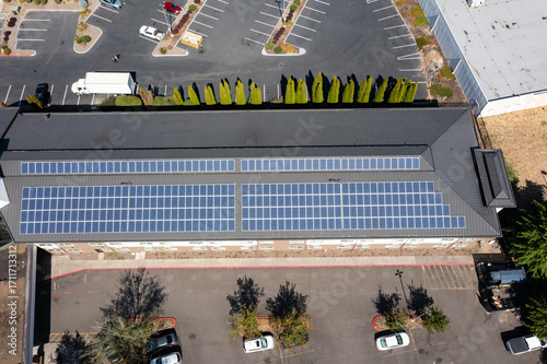 Modern hotel building in Portland, Oregon with rooftop solar panels captured in 4K aerial drone footage, highlighting renewable energy, green technology, clean power, sustainable architecture design
