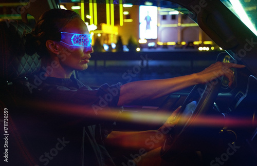 Woman in Futuristic High-tech VR Eyewear driving car in night ci