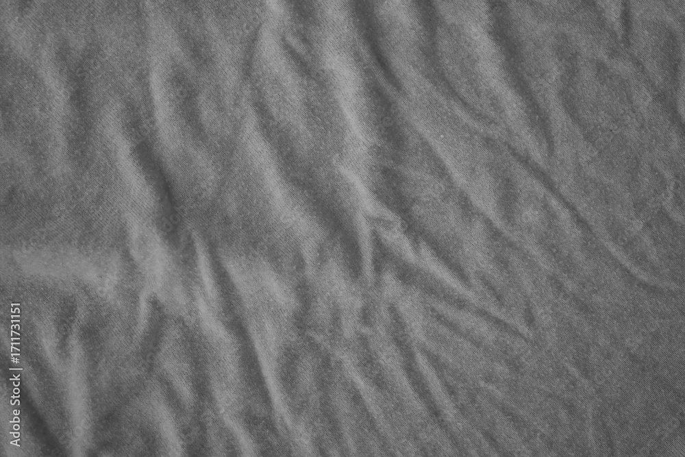 Naklejka premium Texture of Dark grey crumpled textile cloth part with small folds