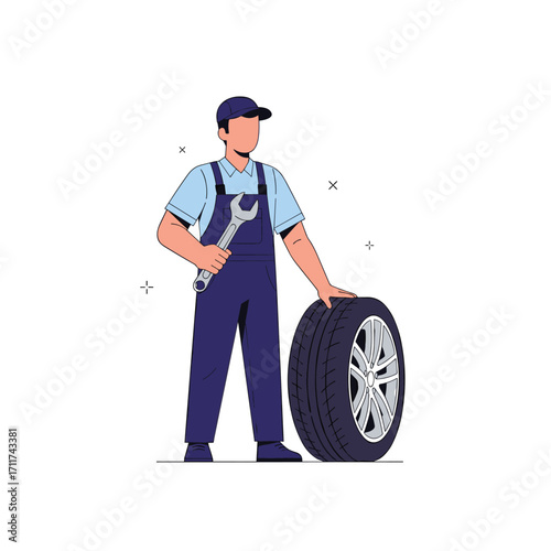 Automobile mechanic holding a wrench and standing with a car tire.