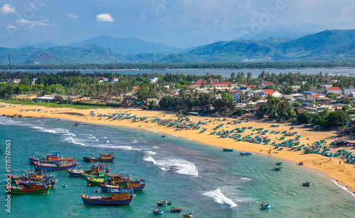 Xuan Hai fishing village in Song Cau, Phu Yen, Vietnam is beautiful with a curved beach with colorful basket boats under the sunlight.