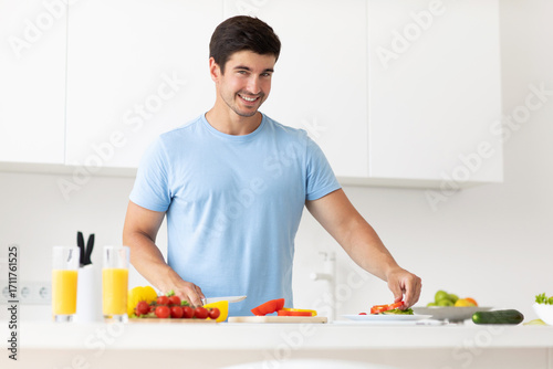Handsome young healthy man preparing healthy vegetable food