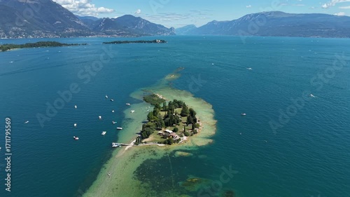 Wallpaper Mural 4K drone footage of Isola di San Biagio on Lake Garda, Italy, highlighting the peaceful summer landscape. Torontodigital.ca