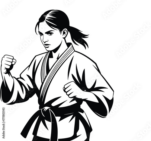 Determined young woman in karate gi ready for combat martial arts training