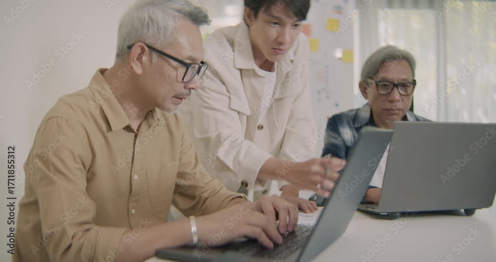 Asian senior adults learning coding and software development with ...