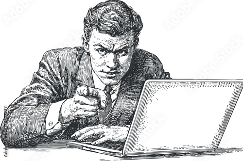 A confident businessman pointing at the viewer while working on a laptop in an office setting.