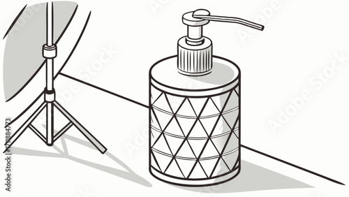 Studio shot of a cylindrical pump bottle with a geometric pattern next to a photography light stand.