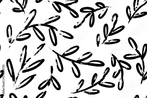 Abstract seamless pattern of hand drawn black brush painted leaves and branches, vector foliage silhouettes forming natural organic botanical ornament. Perfect for textiles, wallpapers, packaging, and