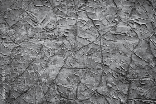 gray background, in the photo the texture of a gray wall with various lines, strokes and cracks